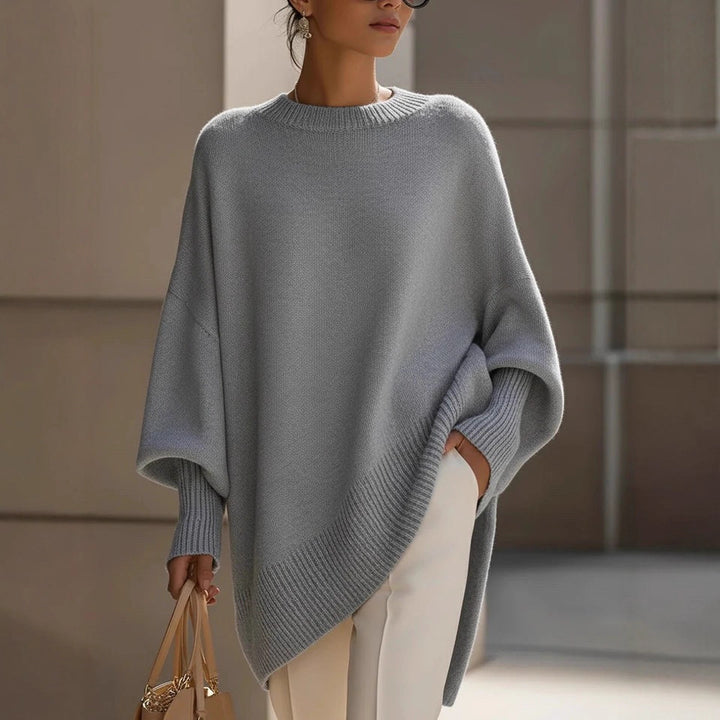 Women's oversized knit poncho with asymmetrical hem and ribbed sleeves Mune Fashion