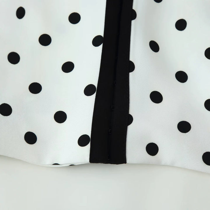 Women's short blazer in polka dot design with round neckline, short cut and contrast piping Mune Fashion
