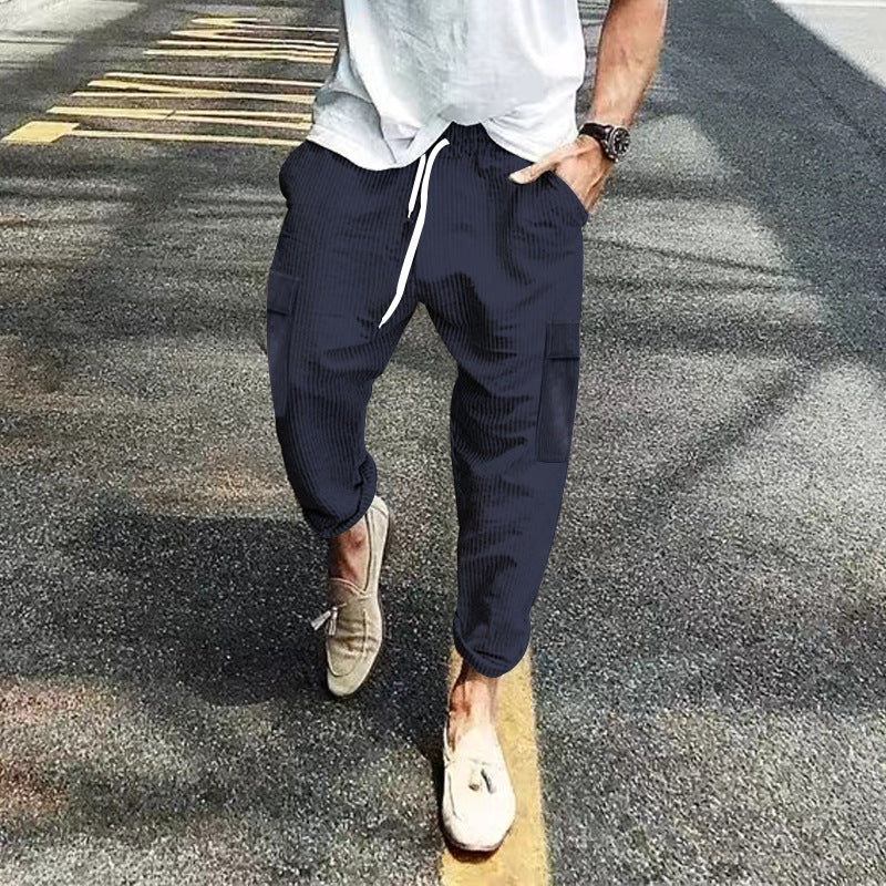 Men's corduroy cargo jogging pants with elastic drawstring waistband, flap pockets, and tapered leg Mune Fashion