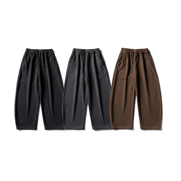 Unisex fleece jogging pants with elastic drawstring waistband, side pockets and tapered leg Mune Fashion