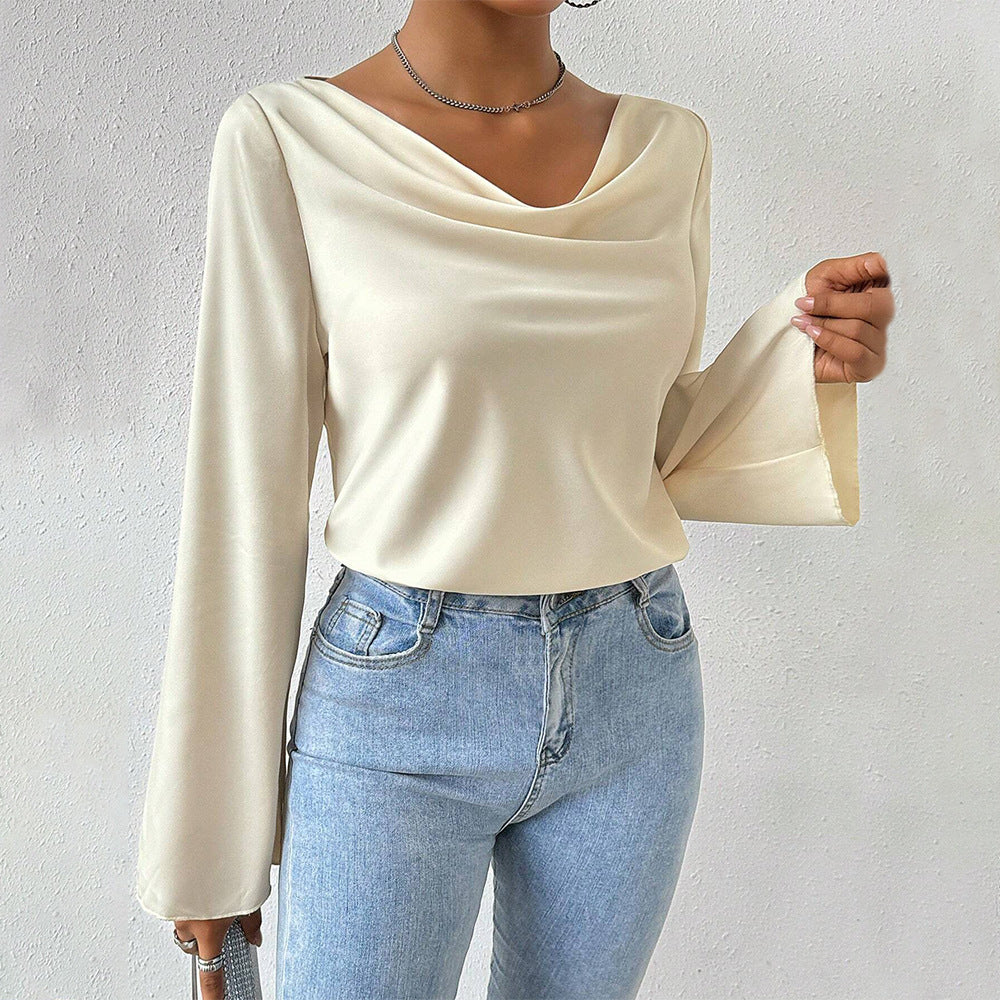 Women's blouse with waterfall neckline, wide trumpet sleeves and flowing satin look.