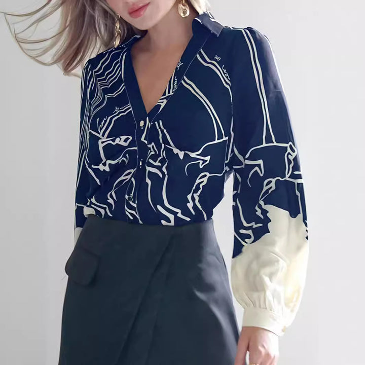 Women's V-neck blouse with abstract graphic print, balloon sleeves, and contrasting cuffs Mune Fashion