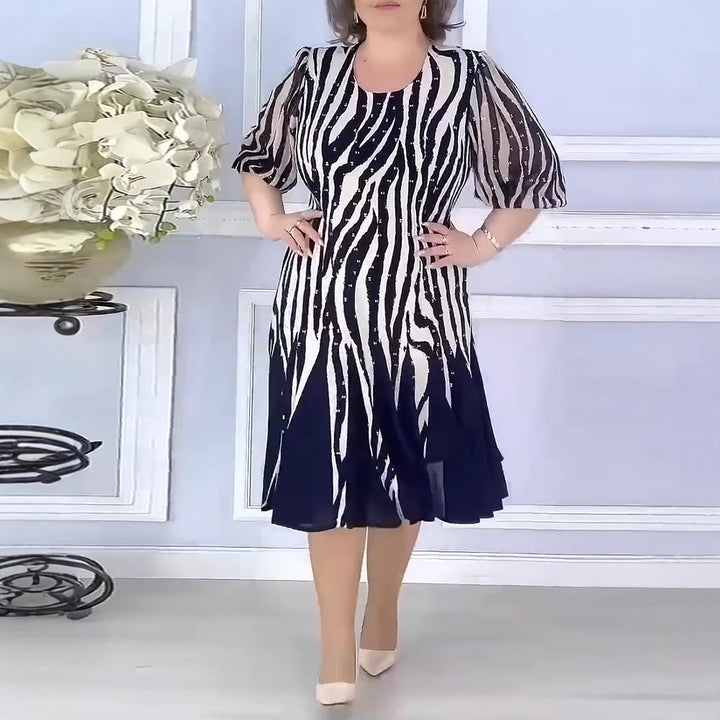 Ladies' fitted midi dress with graphic animal print, transparent puff sleeves and swinging pleated skirt Mune Fashion