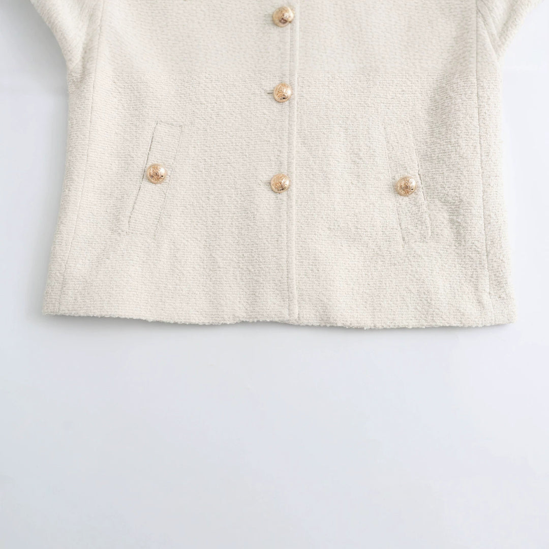 Women's elegant bouclé cropped jacket with round neckline, gold button details, and patch waist pockets Mune Fashion
