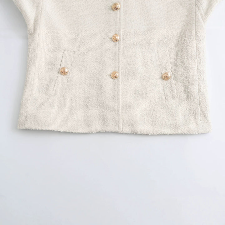 Women's elegant bouclé cropped jacket with round neckline, gold button details, and patch waist pockets Mune Fashion