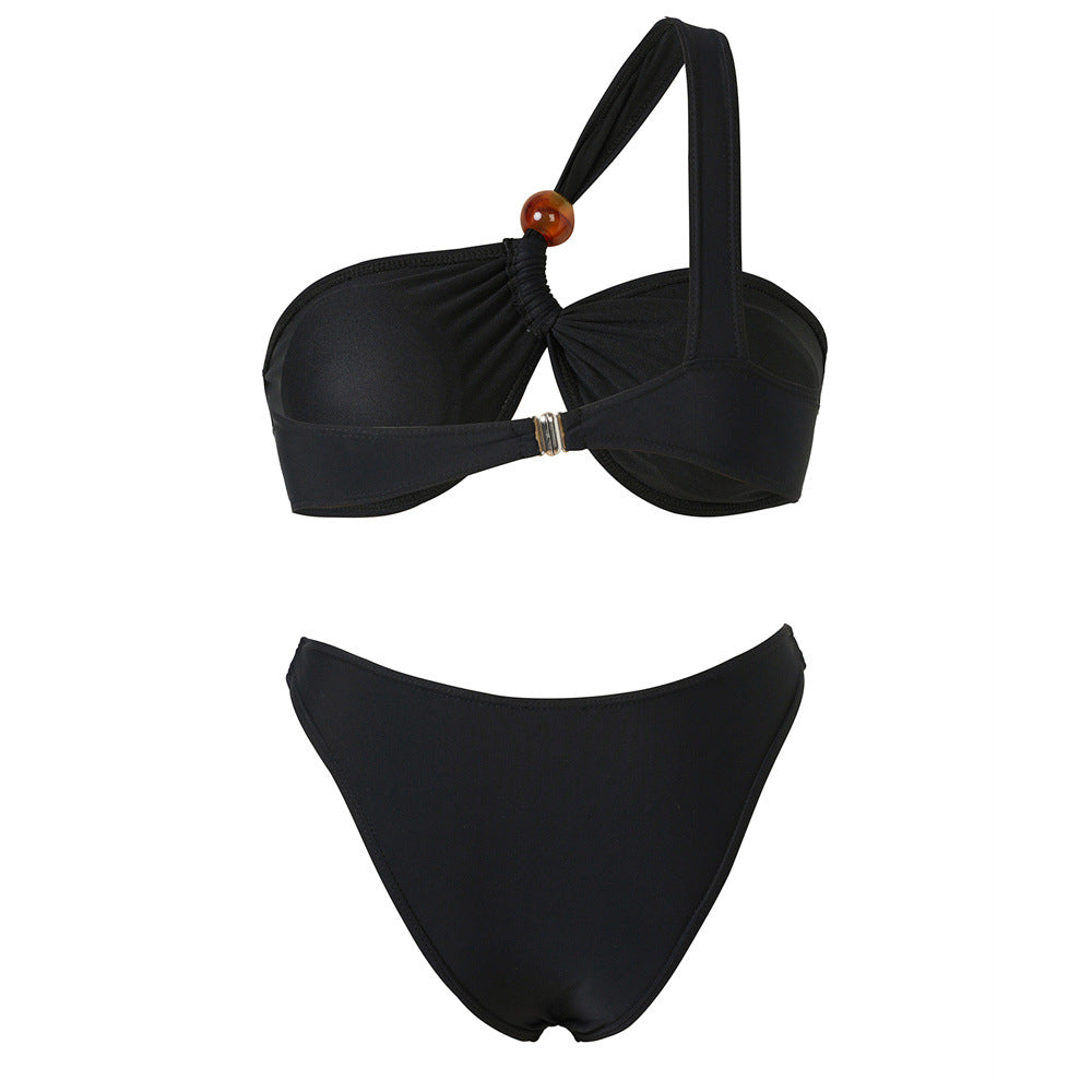 Women's bikini set with asymmetric halter neck and decorative pants buttons Mune Fashion