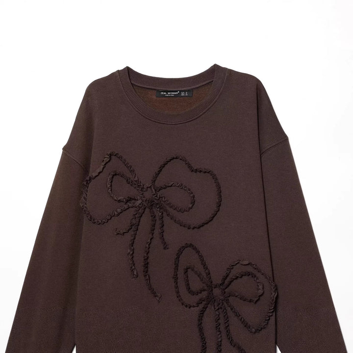 Women's wide sweatshirt with three-dimensional bow application and ribbed cuffs Mune Fashion