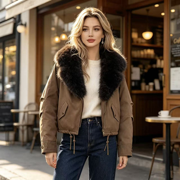Women's short bomber jacket with voluminous faux fur collar, drawstring hem, and flap pockets Mune Fashion