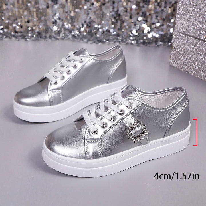 Ladies' platform sneaker with metallic upper material, decorative rhinestone buckle, and padded comfort sole Mune Fashion
