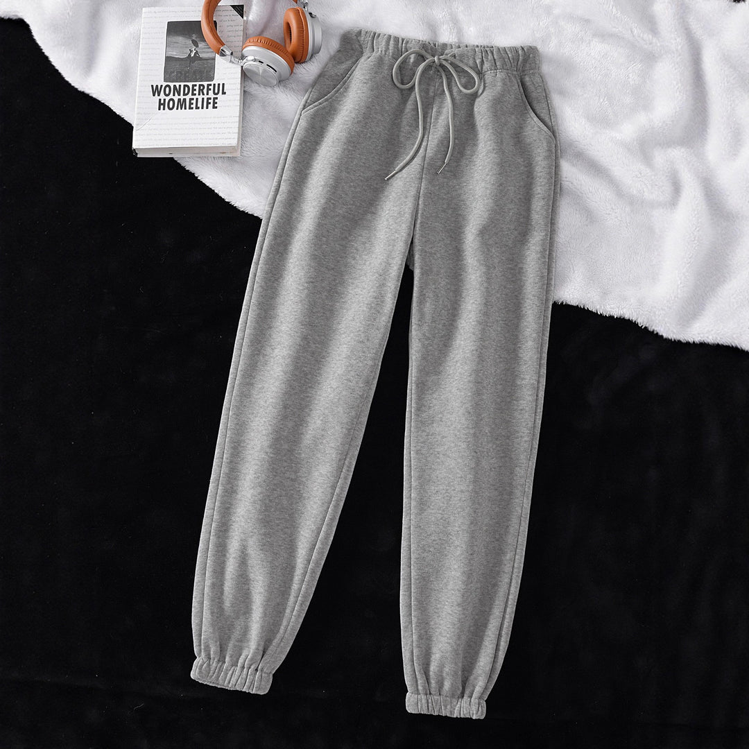Women's high-cut joggers made of soft fleece cotton blend with elastic waistband, drawstring, and side pockets Mune Fashion