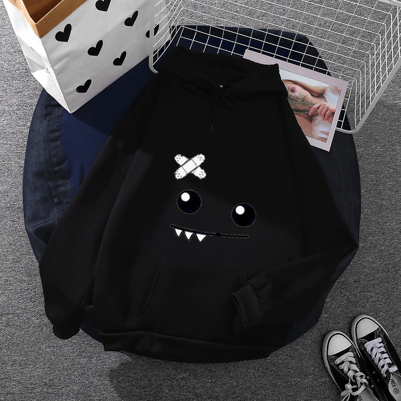 Women's hoodie with playful monster face, bandage application and kangaroo pocket Mune Fashion