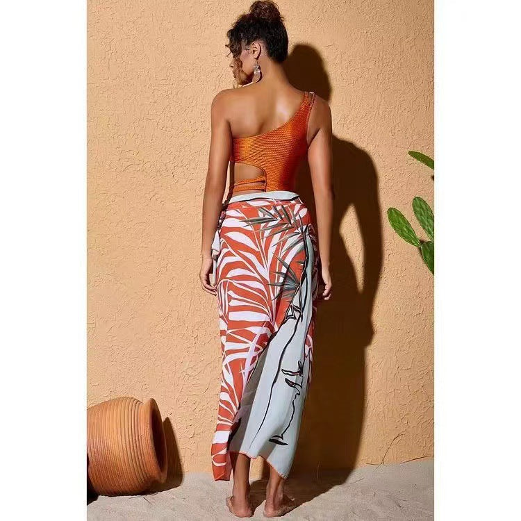 Women’s one-piece swimsuit with asymmetric cut and floral wrap skirt Mune Fashion