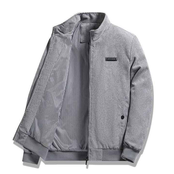 Men's fine corduroy jacket with stand-up collar, striped lining, and concealed snap pockets.