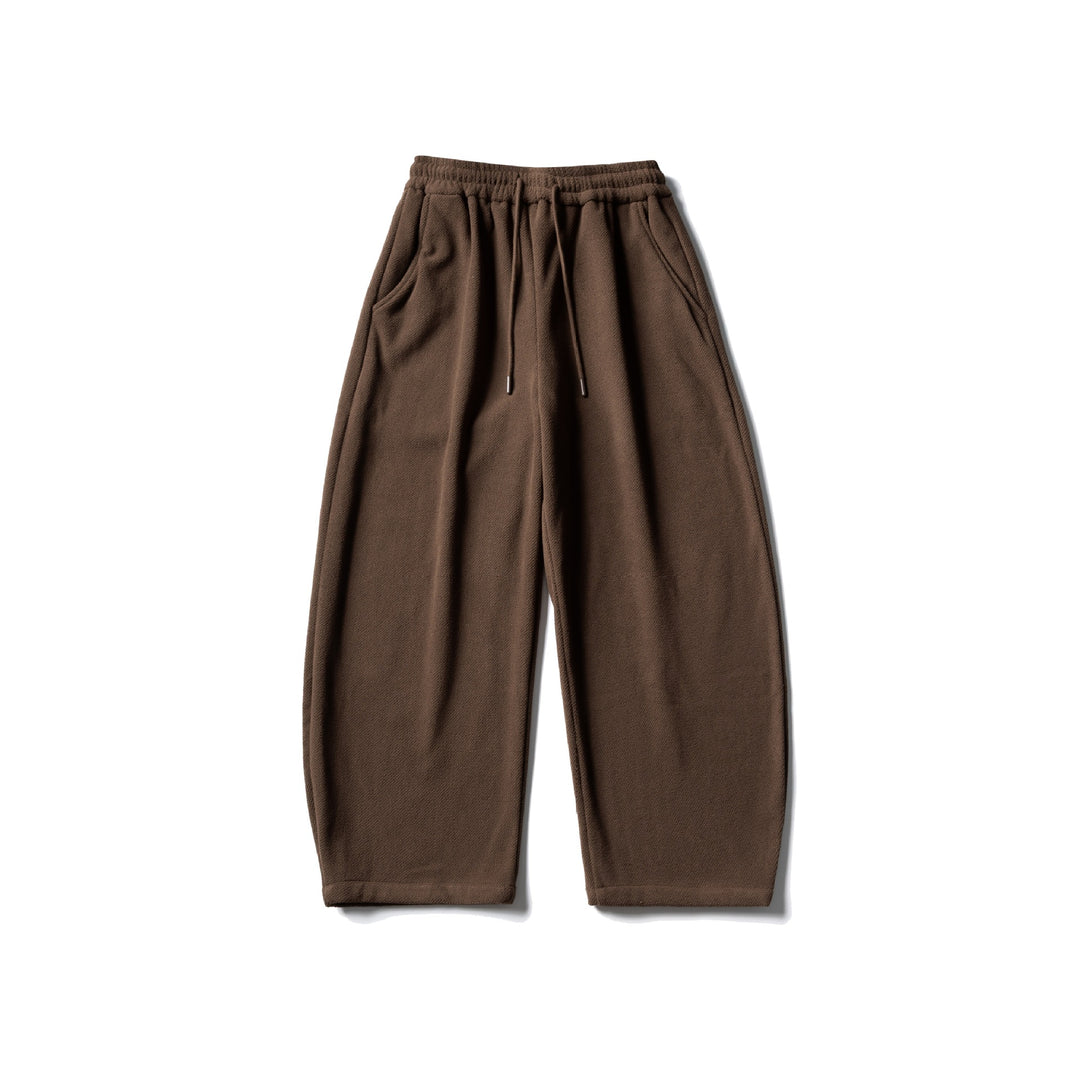 Unisex fleece jogging pants with elastic drawstring waistband, side pockets and tapered leg Mune Fashion
