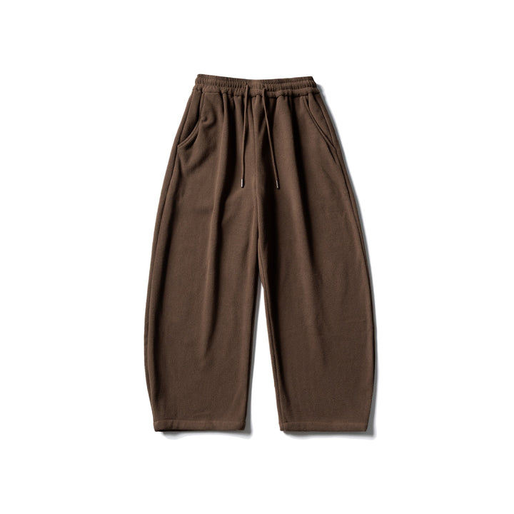 Unisex fleece jogging pants with elastic drawstring waistband, side pockets and tapered leg Mune Fashion