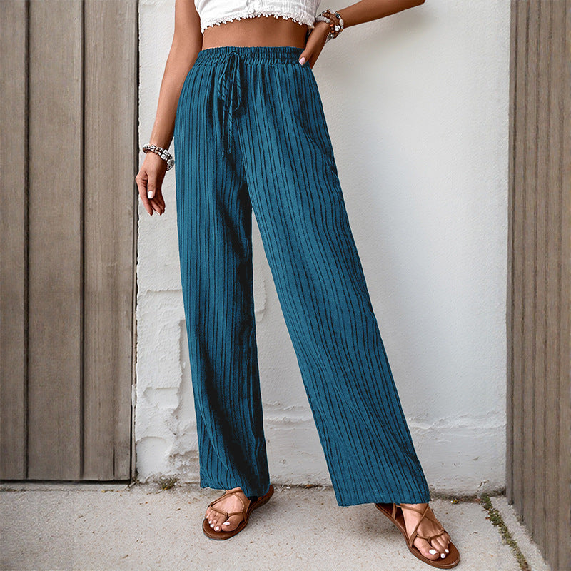 Women's loose summer trousers made from lightweight crinkle fabric with elastic waistband and drawstring.