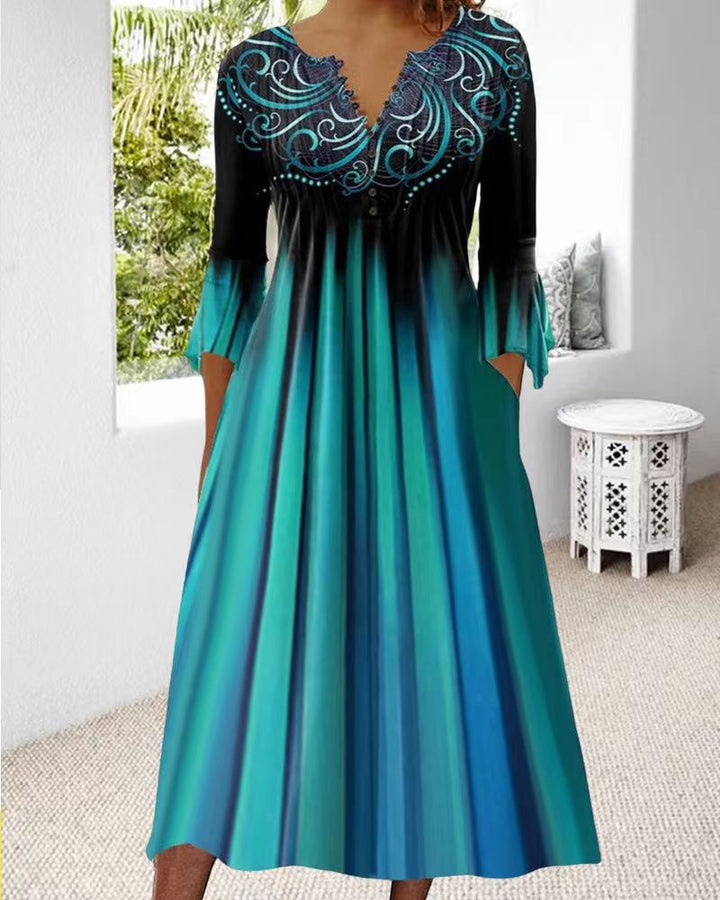 Women's flowing maxi dress with embellished V-neck, underbust seam, flared skirt and side pockets Mune Fashion