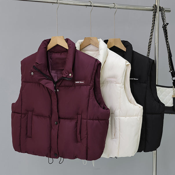 Women's short cut thermo quilted vest with high stand-up collar, snap button front and adjustable drawstring hem Mune Fashion