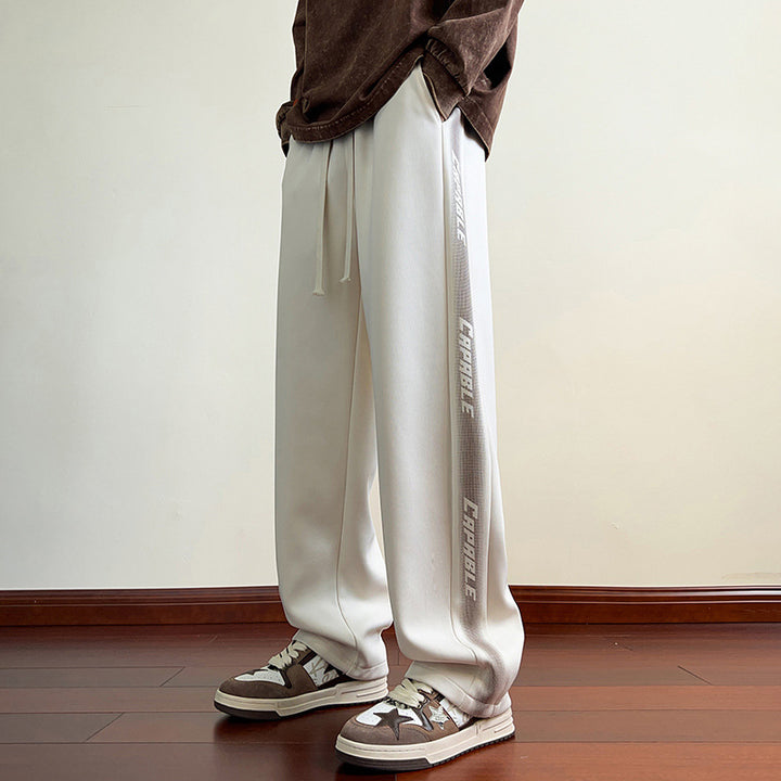 Men's sporty leisure pants with elastic waistband and side graphics