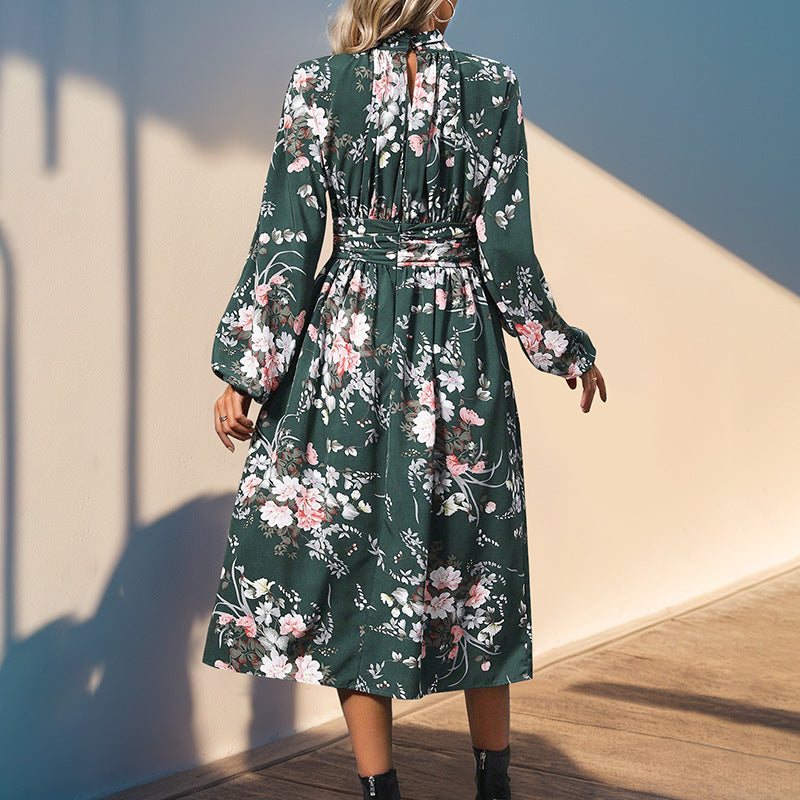 Women's midi dress with floral all-over print, stand collar and draped waist belt.