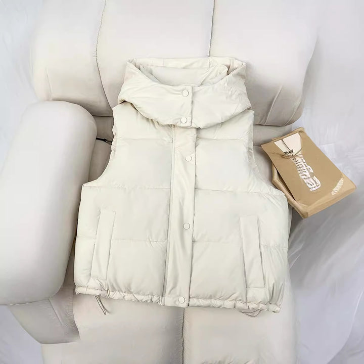 Women’s short quilted vest with voluminous stand-up collar, snap button placket, and adjustable drawstring hem Mune Fashion