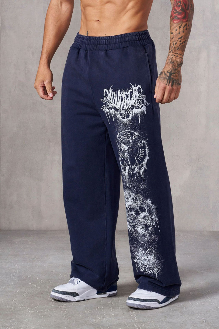 Men's baggy joggers with elastic waistband, side pockets and detailed skull and rose motif Mune Fashion