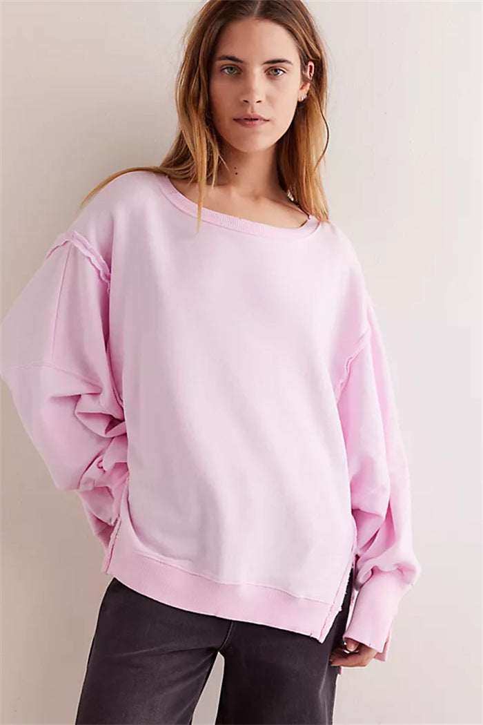 Women's oversized sweatshirt with balloon sleeves, open seam stitches, and side slits Mune Fashion