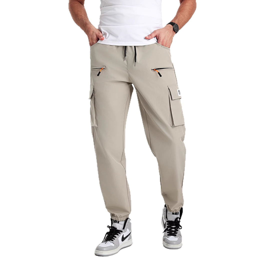 Men's tapered cut utility cargo pants in jogger style with drawstring waistband, zippered pockets & elastic leg cuffs Mune Fashion