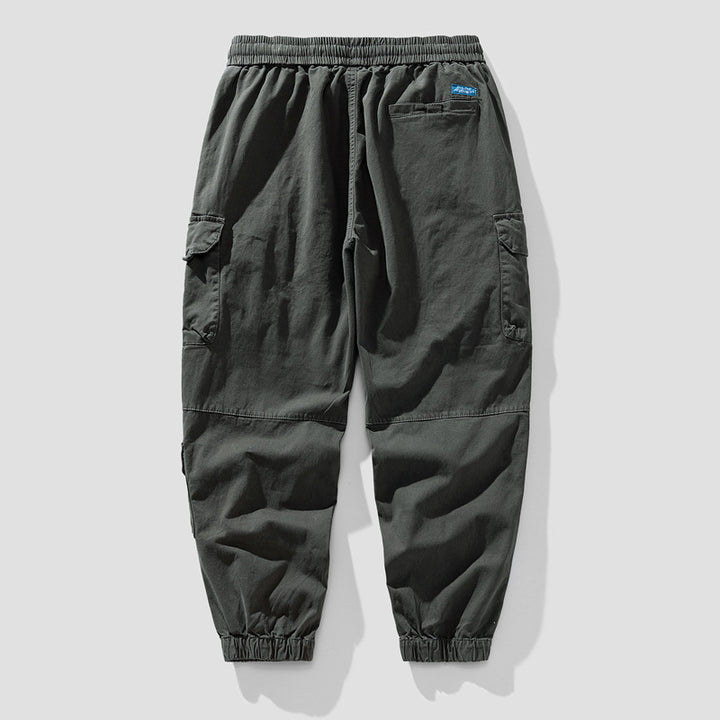 Herren Leichte Canvas-Cargohose im Joggerstil mit elastischem Bund, segmentierten Kniepaneelen und verdeckten Klappentaschen Mune Fashion