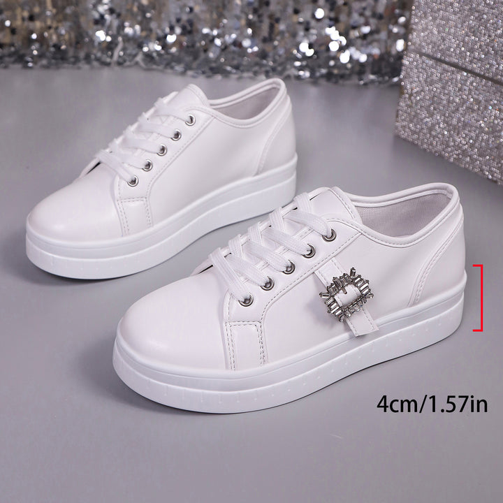 Ladies' platform sneaker with metallic upper material, decorative rhinestone buckle, and padded comfort sole Mune Fashion