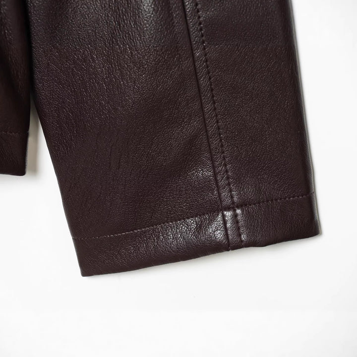 Women's short jacket in vegan leather look with cinching drawstring and flap pockets Mune Fashion