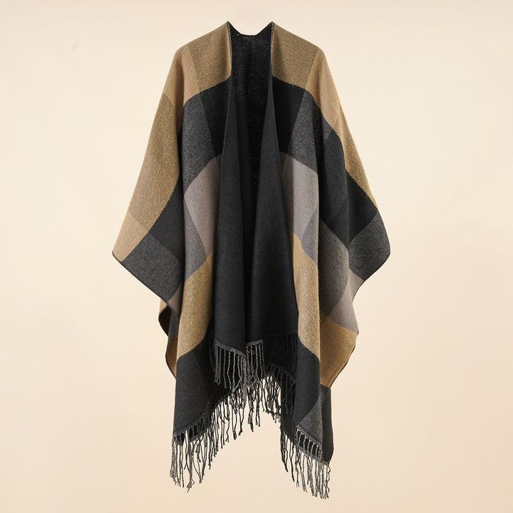 Women’s web cape in a boxy ruana cut with diagonal check pattern and fringes