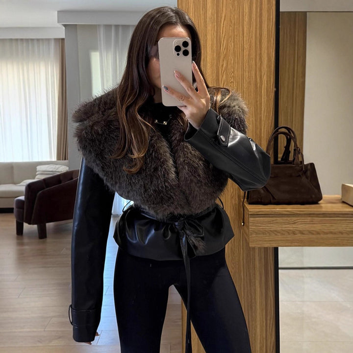 Women's short jacket in biker blouson style made of imitation leather with voluminous faux fur shawl collar and waist belt Mune Fashion