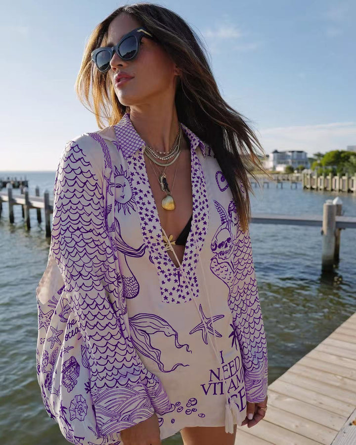 Ladies lightweight beach cover-up in tunic form with deep V-neck, tassel closure, and nautical ocean print Mune Fashion
