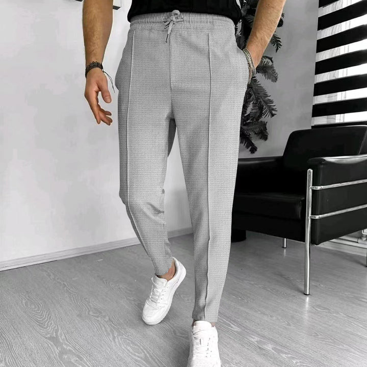 Men's tapered jogging chinos made of structured woven quality with elastic drawstring waistband and decorative crease Mune Fashion