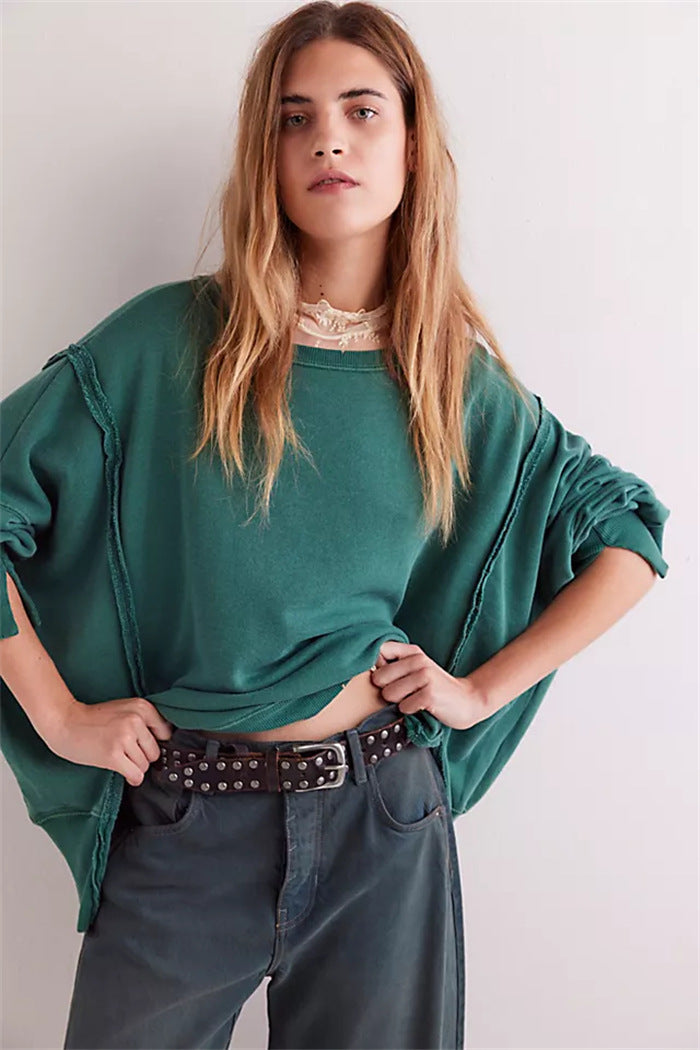 Women's oversized sweatshirt with balloon sleeves, open seam stitches, and side slits Mune Fashion