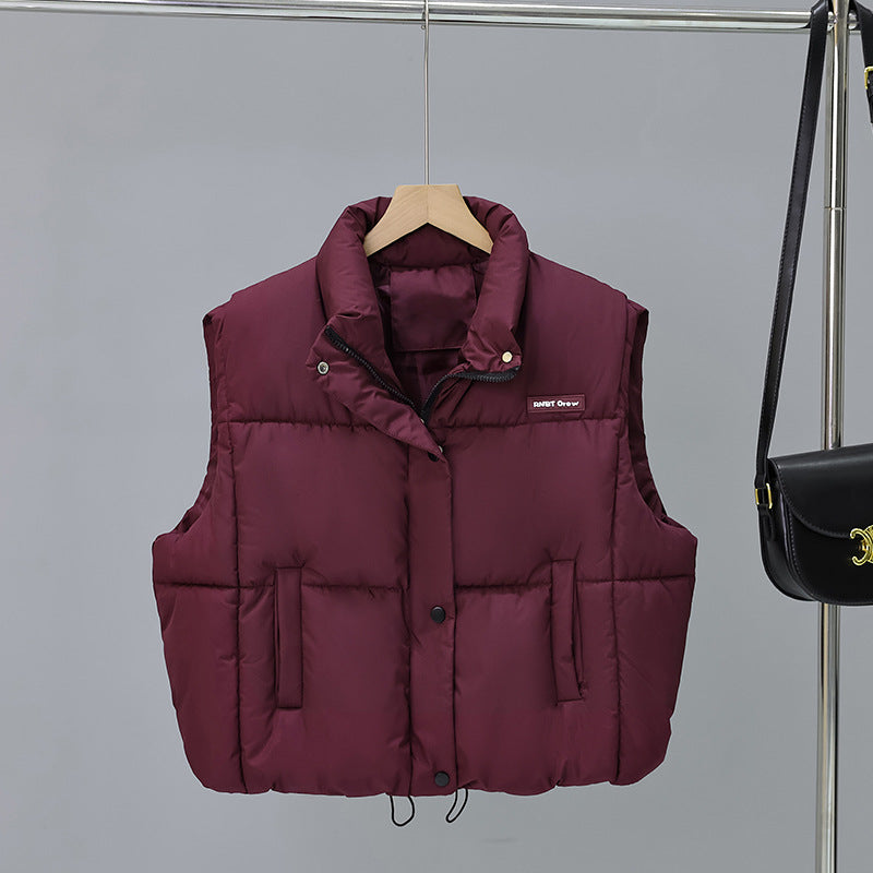 Women's short cut thermo quilted vest with high stand-up collar, snap button front and adjustable drawstring hem Mune Fashion