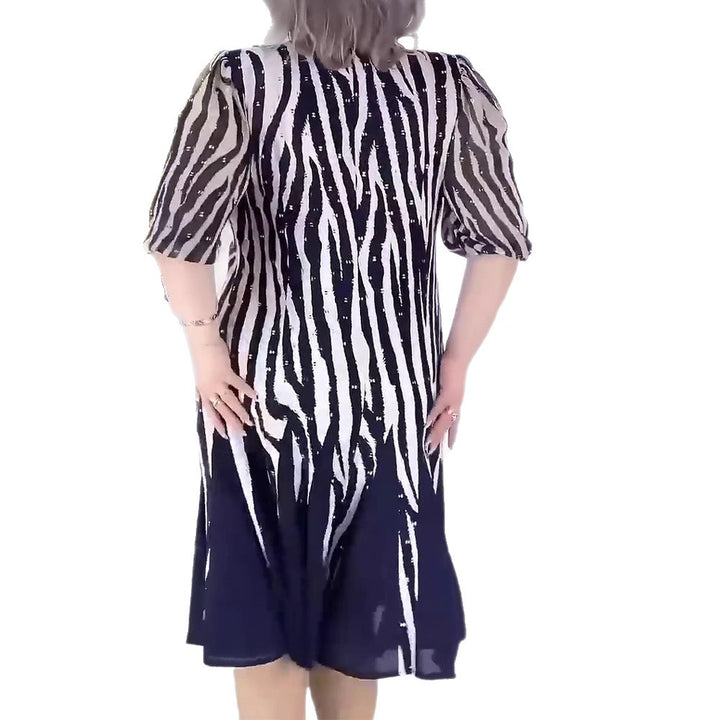 Ladies' fitted midi dress with graphic animal print, transparent puff sleeves and swinging pleated skirt Mune Fashion