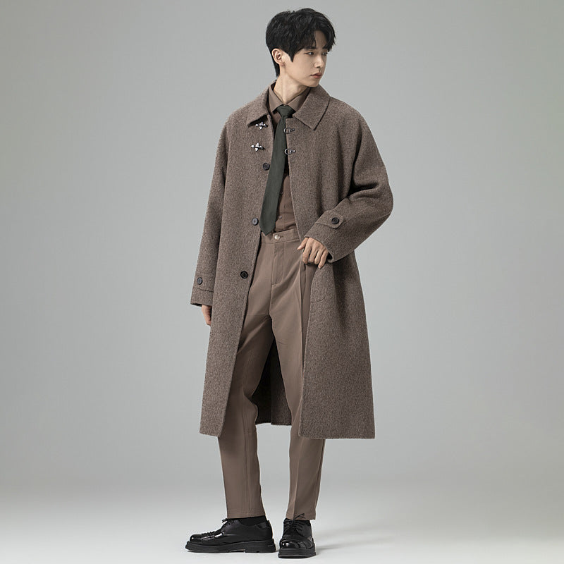 Men's floor-length wool blend coat in oversized cut with distinctive hook closures Mune Fashion