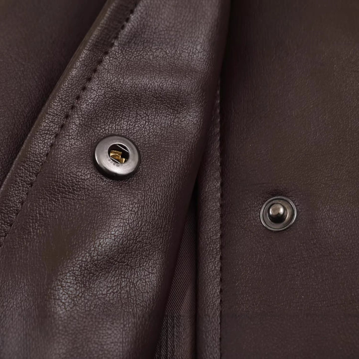 Women's oversized faux leather bomber jacket with stand-up collar, elastic hem, and concealed snap button placket Mune Fashion