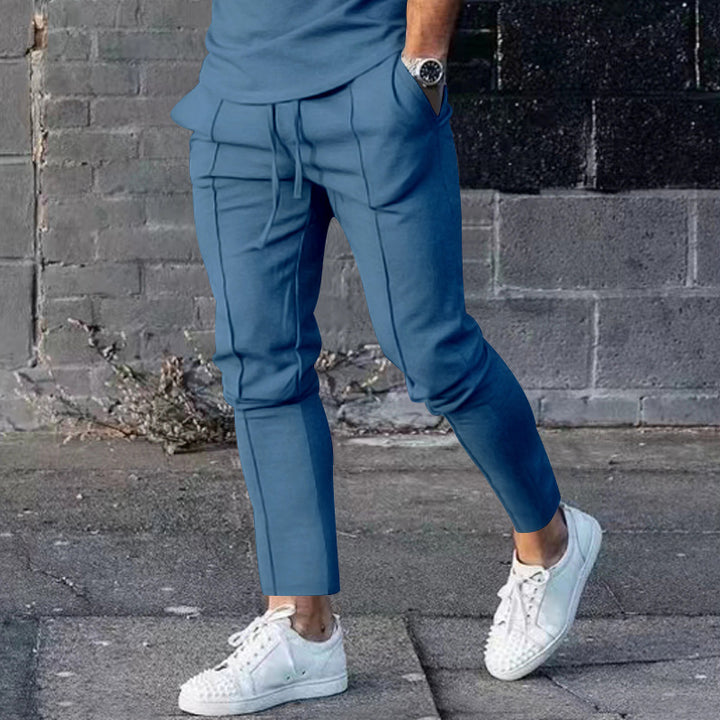 Men's Slim Tapered Jogging Pants with decorative stitching, elastic drawstring, and narrow ankle cuffs Mune Fashion