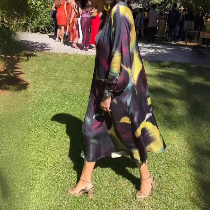 Women's flowing midi dress with abstract print, V-neckline, balloon sleeves, and decorative closure Mune Fashion