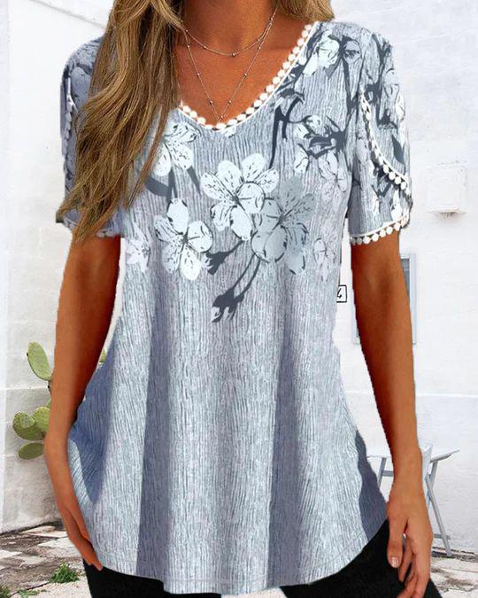 Women's flowing V-neck tunic top with floral print pompom trim and A-line cut Mune Fashion
