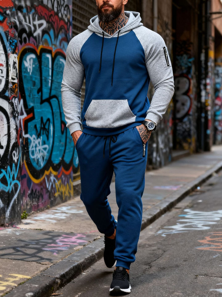 Men's two-piece hooded sweat set with raglan sleeves, sleeve zip pocket, and tapered jogging pants Mune Fashion