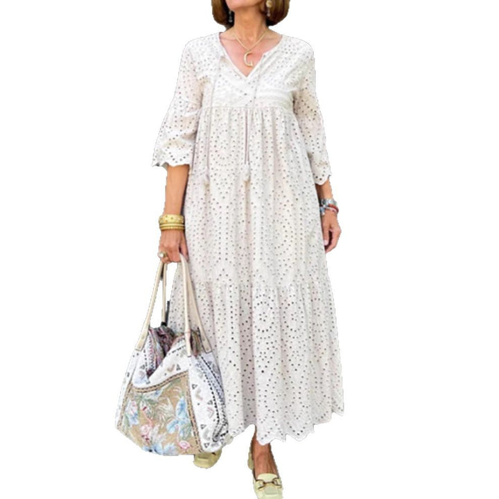 Women's flowing maxi dress with openwork embroidery, V-neck, underbust seam, and ruffled skirt Mune Fashion