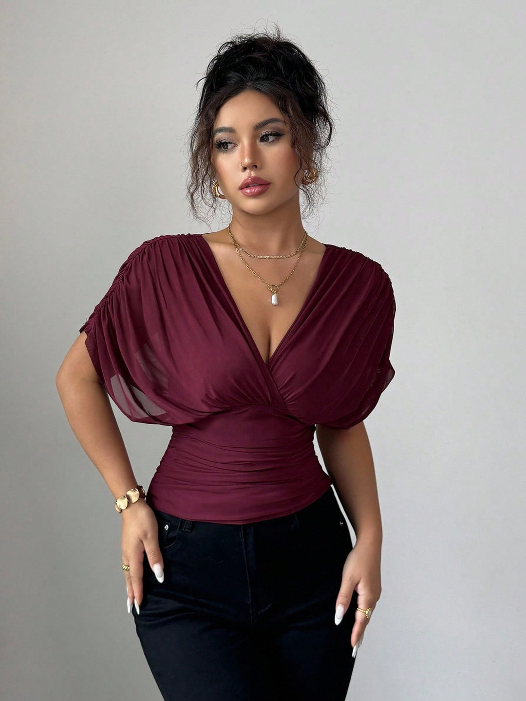 Women's fitted wrap top with deep V-neck and gathered wing sleeves Mune Fashion
