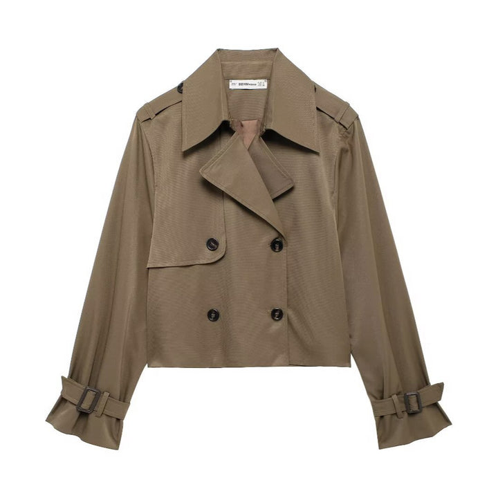 Women's short cropped trench coat in boxy cut with double-breasted button placket, shoulder epaulets and adjustable sleeve straps Mune Fashion