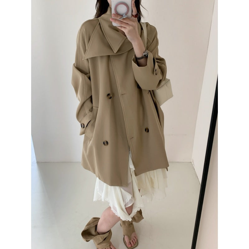 Women’s short trench coat with extra wide lapels, raglan sleeves, and horn button details Mune Fashion