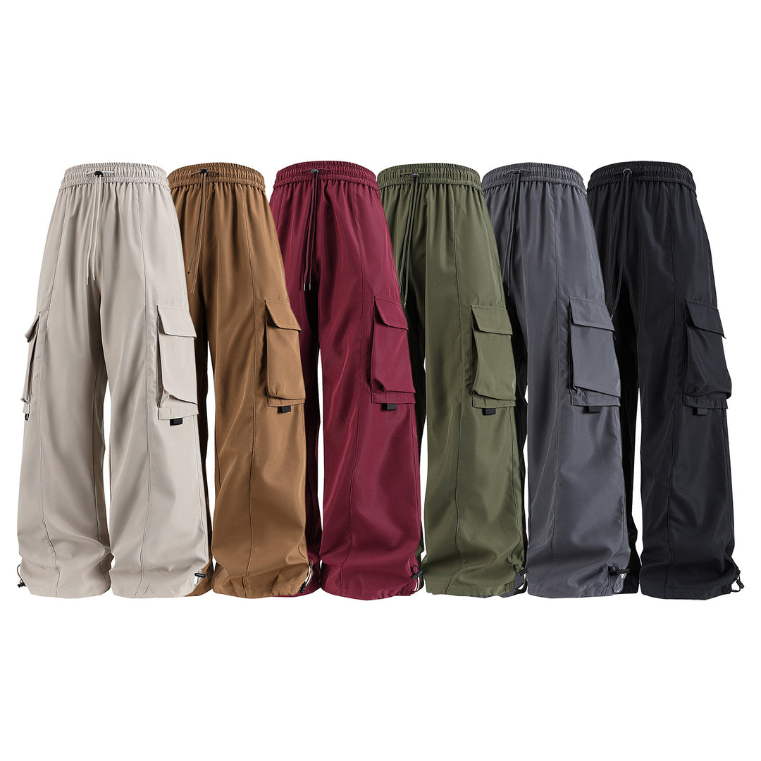 Men's wide utility cargo pants in baggy cut with drawstring waistband, large flap pockets, and adjustable leg hems Drune