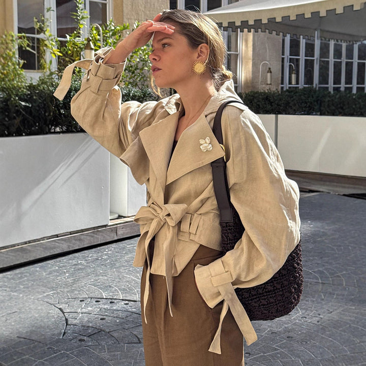Women’s short trench coat with waist knot detail, cape sleeves, and boxy cropped cut Mune Fashion